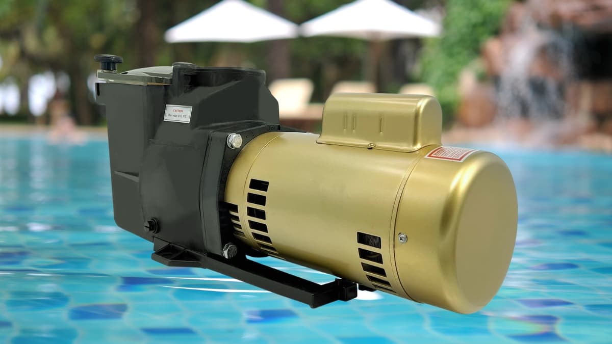 Gold replacement pool pump motor attached to a black housing unit, shown near a clear blue swimming pool.