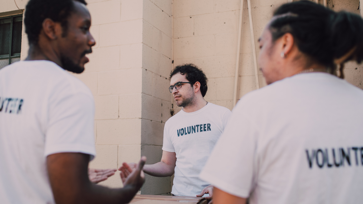 Malteser Works volunteers discussing community outreach plans outside a building
