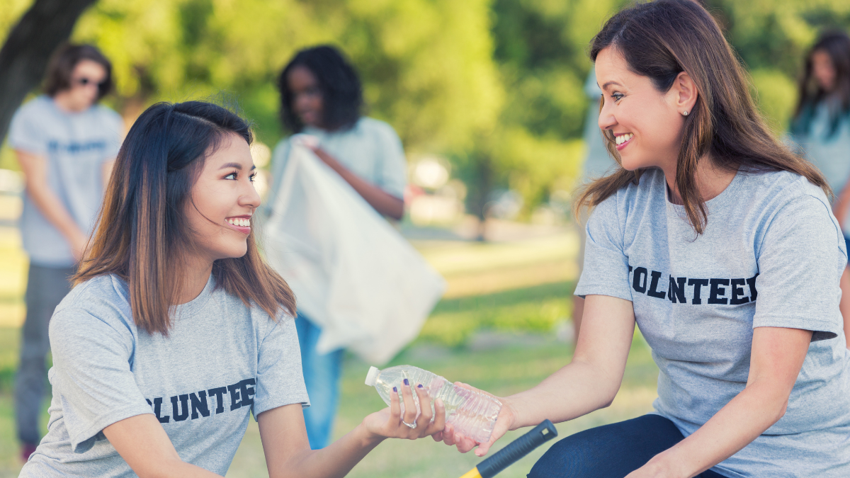 Malteser DE volunteers smiling while working together during a community outreach event in a park