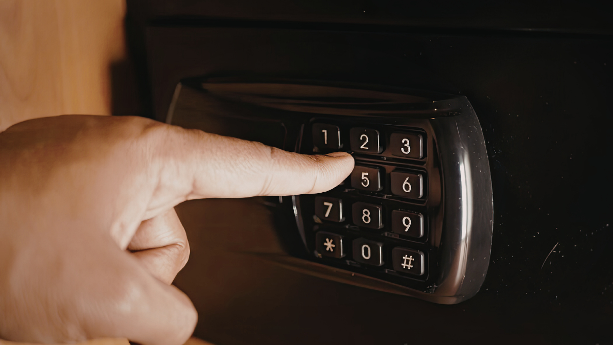 Electronic keypad safe with hand entering security code for protection
