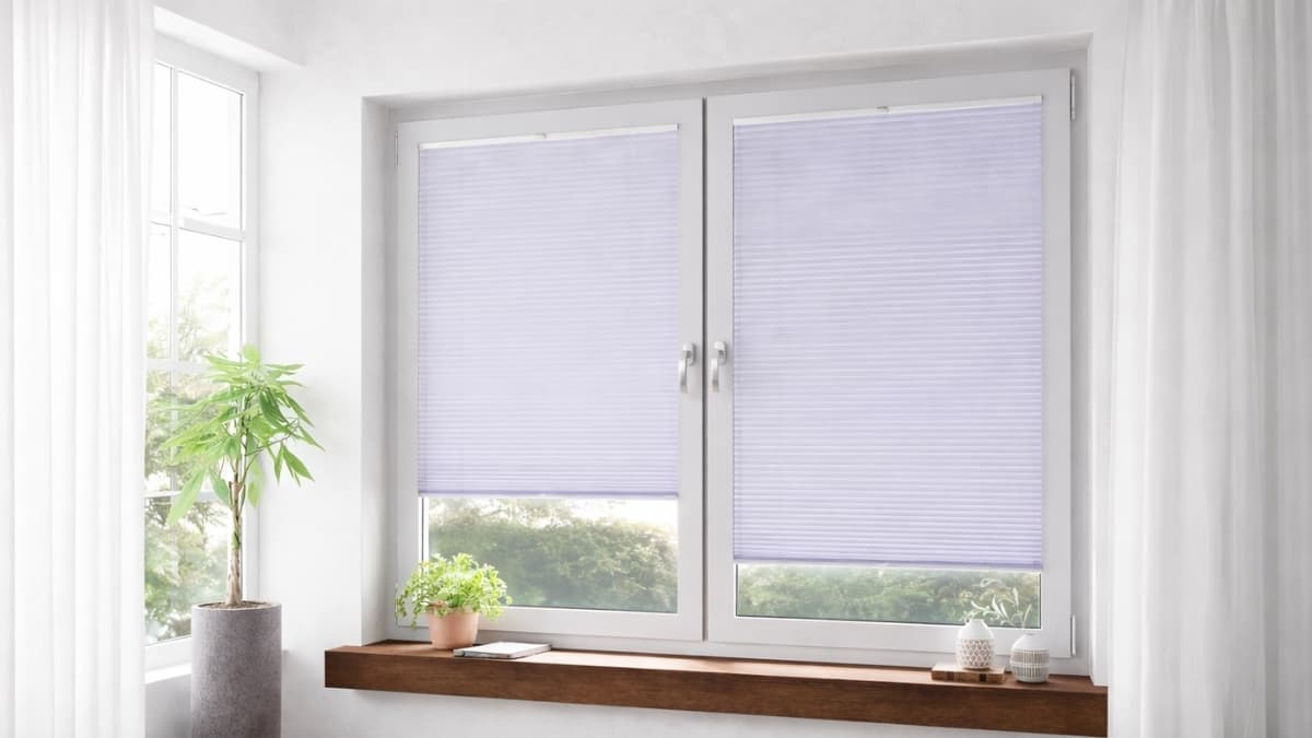 Schattenfreu Honeycomb Pleated Blinds installed on white double window in modern bright living room