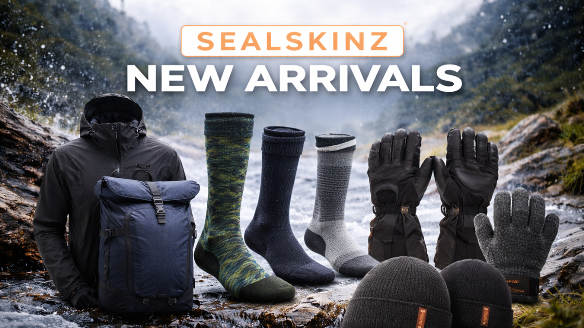 Sealskinz New Arrivals banner featuring waterproof jacket, backpack, socks, gloves, and beanies displayed on rocks beside a flowing mountain stream.